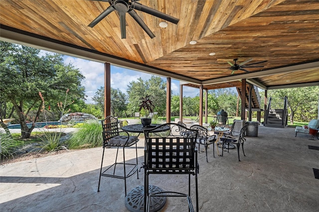 8029 N River Xing, China Spring, TX 76633 - view of patio / terrace featuring stairs, a ceiling fan, outdoor dining space, and view of scattered trees