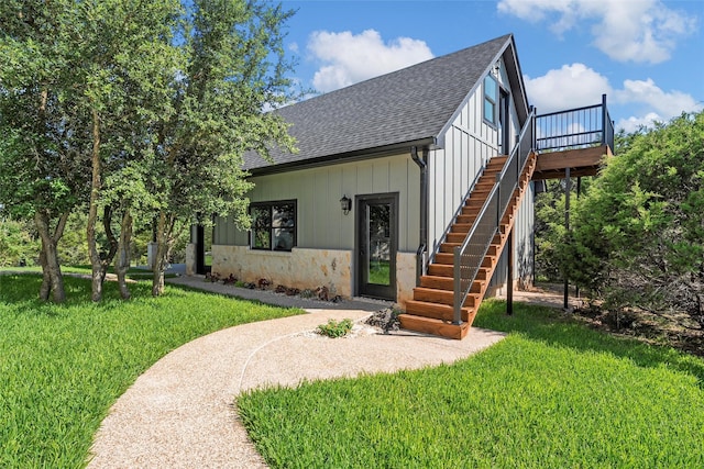 8029 N River Xing, China Spring, TX 76633 - view of front of house with a shingled roof, stairs, a front yard, and a wooden deck