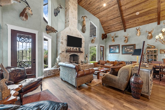 8029 N River Xing, China Spring, TX 76633 - living area featuring high vaulted ceiling, a wooden ceiling with exposed beams, plenty of natural light, wood finished floors, and a large fireplace