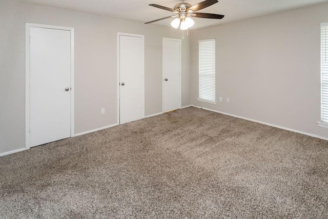 6908 Briardale Dr, North Richland Hills, TX 76182 - unfurnished bedroom featuring carpet, multiple closets, and a ceiling fan