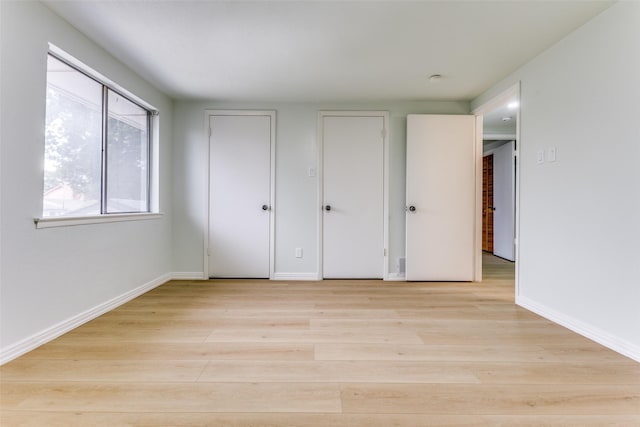 2018 Vail Dr, Garland, TX 75044 - unfurnished bedroom with light wood finished floors and baseboards