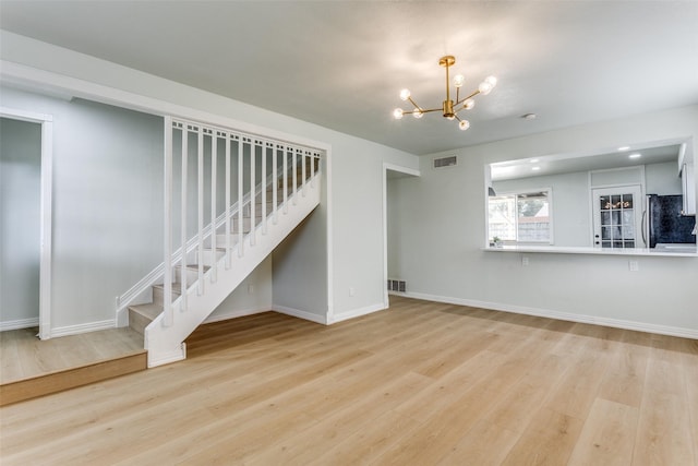 2018 Vail Dr, Garland, TX 75044 - unfurnished living room with stairway, a chandelier, and wood finished floors