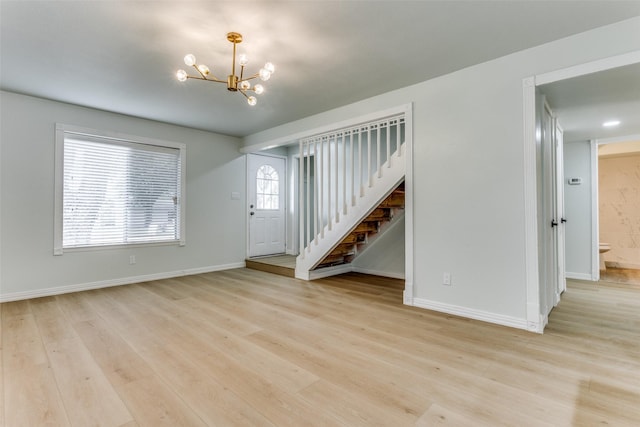 2018 Vail Dr, Garland, TX 75044 - unfurnished living room with a chandelier, stairway, and light wood-type flooring