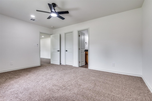2775 E Overton Rd, Dallas, TX 75216 - unfurnished bedroom with dark colored carpet, connected bathroom, and ceiling fan