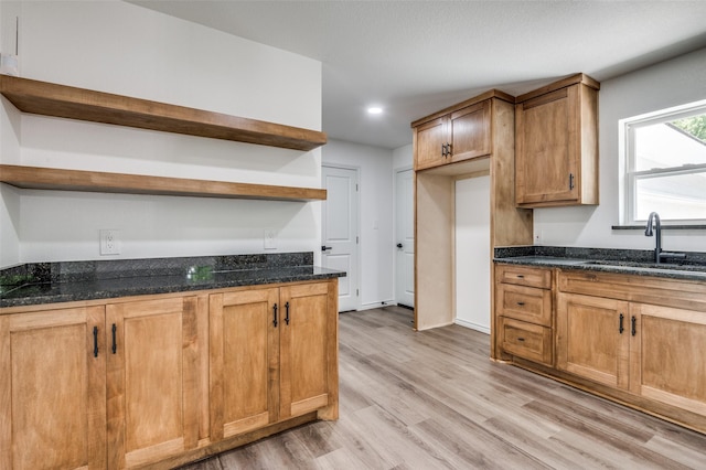 2775 E Overton Rd, Dallas, TX 75216 - kitchen with open shelves, dark stone counters, light wood-style floors, recessed lighting, and brown cabinetry