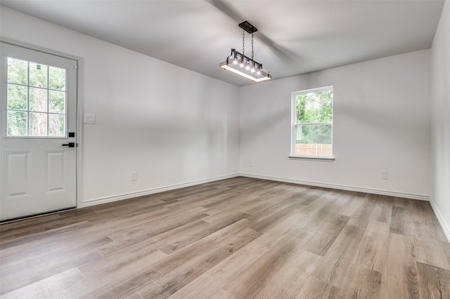 2775 E Overton Rd, Dallas, TX 75216 - unfurnished dining area with light wood finished floors and baseboards