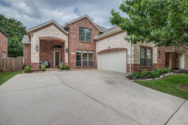 1909 Rocky Ct, Corinth, TX 76208 - view of front of house featuring concrete driveway, a garage, stone siding, and brick siding