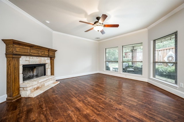 1909 Rocky Ct, Corinth, TX 76208 - unfurnished living room with dark wood-style floors, ornamental molding, healthy amount of natural light, a ceiling fan, and a stone fireplace