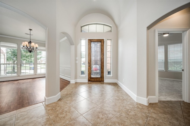 1909 Rocky Ct, Corinth, TX 76208 - entryway featuring arched walkways, a chandelier, tile patterned floors, and ceiling fan