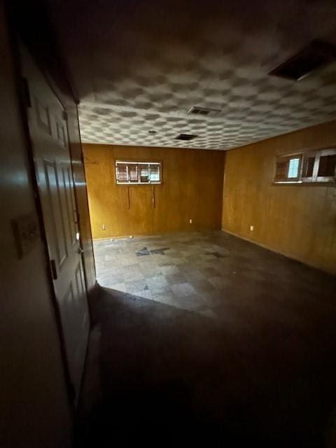 4973 Dupont Dr, Dallas, TX 75216 - basement featuring wooden walls and tile patterned floors