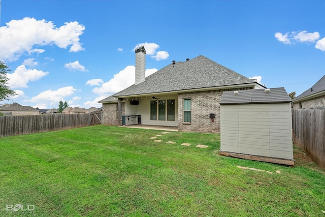 140 St Andrews Ln, Benton, LA 71006 - rear view of property featuring brick siding, a fenced backyard, a chimney, a patio area, and a shingled roof