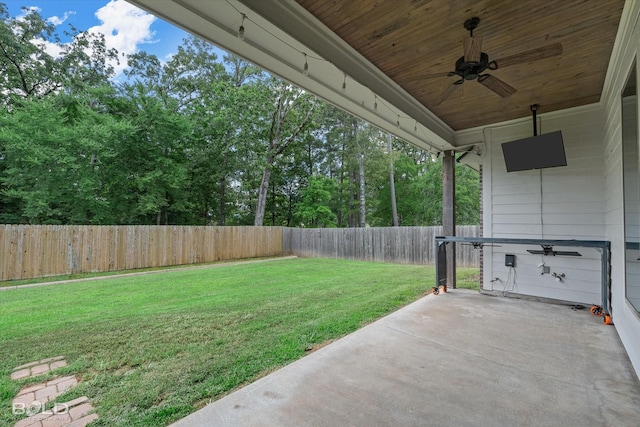 140 St Andrews Ln, Benton, LA 71006 - fenced backyard featuring a ceiling fan, a patio area, and view of wooded area