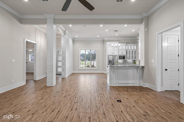 140 St Andrews Ln, Benton, LA 71006 - unfurnished living room with light wood-style flooring, ceiling fan, ornamental molding, recessed lighting, and ornate columns