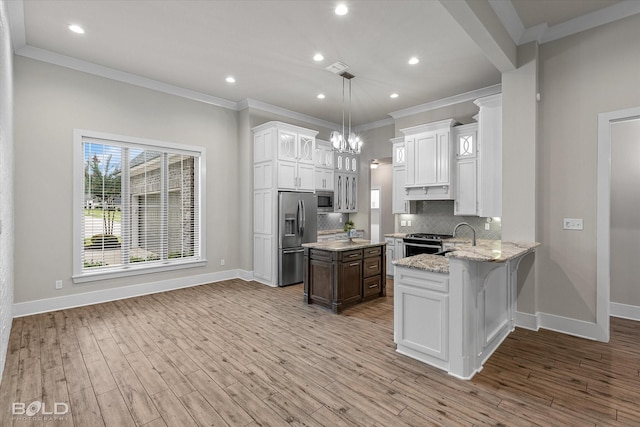 140 St Andrews Ln, Benton, LA 71006 - kitchen with stainless steel appliances, white cabinetry, decorative backsplash, crown molding, and light stone countertops