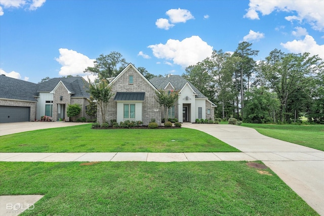140 St Andrews Ln, Benton, LA 71006 - view of front facade with concrete driveway, a front lawn, and stone siding