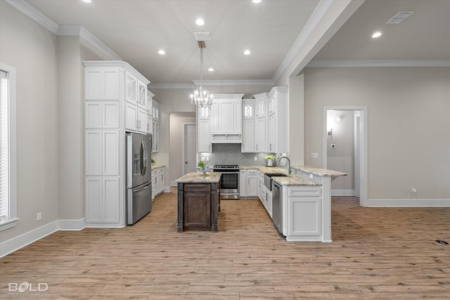 140 St Andrews Ln, Benton, LA 71006 - kitchen featuring stainless steel appliances, ornamental molding, light wood-style flooring, backsplash, and white cabinetry
