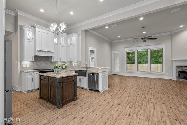 140 St Andrews Ln, Benton, LA 71006 - kitchen with open floor plan, freestanding refrigerator, stainless steel dishwasher, light wood finished floors, and decorative backsplash