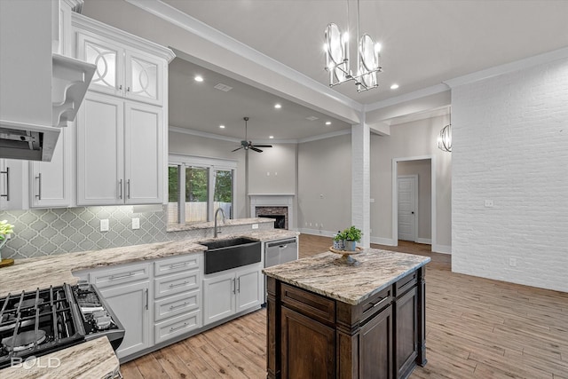 140 St Andrews Ln, Benton, LA 71006 - kitchen with a ceiling fan, a fireplace, ornamental molding, light wood-type flooring, and white cabinetry