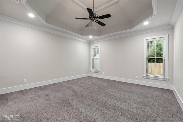140 St Andrews Ln, Benton, LA 71006 - empty room with a tray ceiling, crown molding, plenty of natural light, dark carpet, and a ceiling fan
