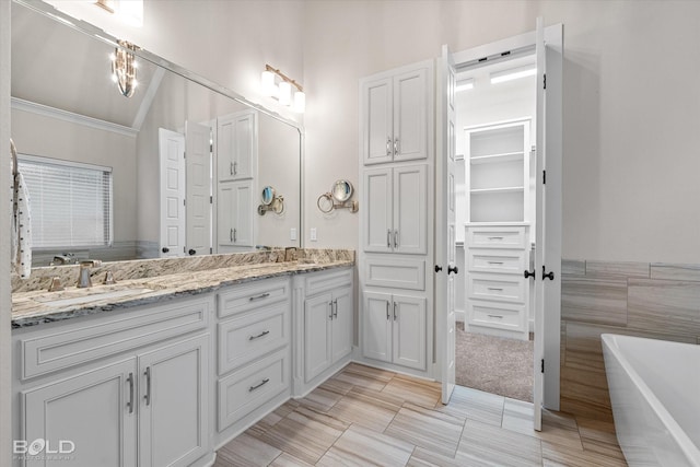 140 St Andrews Ln, Benton, LA 71006 - full bath featuring double vanity, a freestanding bath, ornamental molding, and a walk in closet