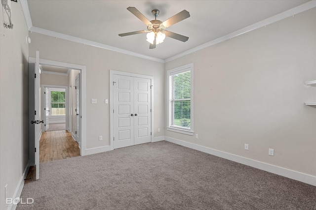 140 St Andrews Ln, Benton, LA 71006 - unfurnished bedroom featuring crown molding, carpet floors, multiple windows, a closet, and ceiling fan