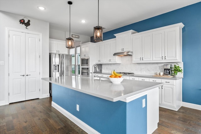 3005 Landmark Pl, Heath, TX 75126 - kitchen featuring stainless steel appliances, under cabinet range hood, white cabinets, tasteful backsplash, and dark wood-type flooring