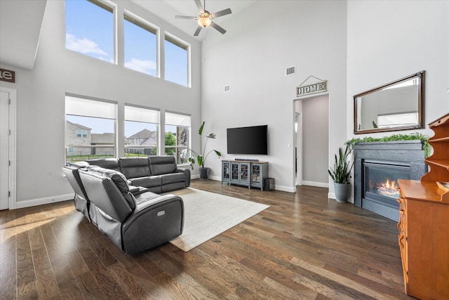 3005 Landmark Pl, Heath, TX 75126 - living room with a high ceiling, a ceiling fan, a glass covered fireplace, and wood finished floors