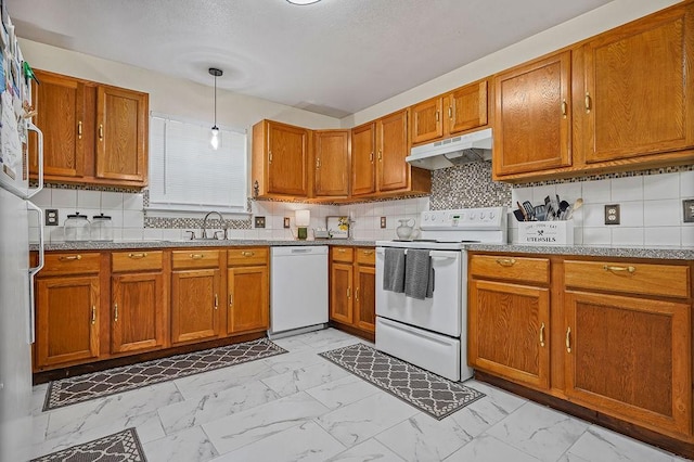 1011 Reed Rd, Denton, TX 76205 - kitchen featuring white appliances, under cabinet range hood, light marble finish flooring, brown cabinets, and a textured ceiling
