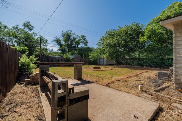 733 N Willis St, Abilene, TX 79603 - fenced backyard with a storage unit and a patio
