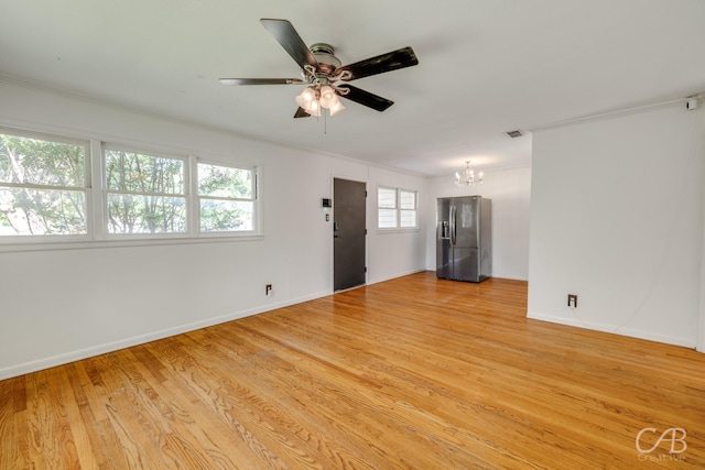 733 N Willis St, Abilene, TX 79603 - unfurnished living room featuring a chandelier, ceiling fan, light wood-type flooring, and crown molding