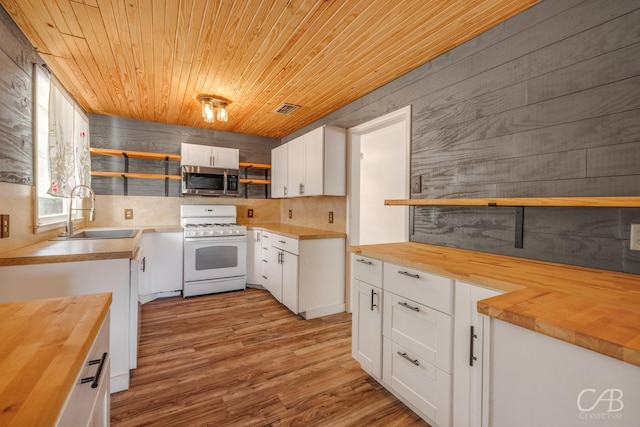 733 N Willis St, Abilene, TX 79603 - kitchen featuring wooden counters, white range with gas cooktop, open shelves, stainless steel microwave, and wooden ceiling