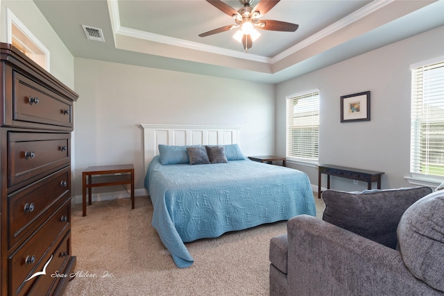 7362 Connor Rd, Abilene, TX 79602 - bedroom with multiple windows, a tray ceiling, crown molding, light carpet, and ceiling fan