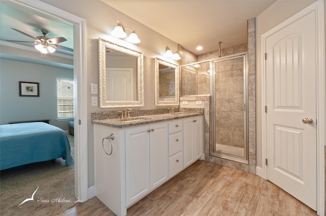 7362 Connor Rd, Abilene, TX 79602 - ensuite bathroom with a shower stall, double vanity, wood finished floors, and ceiling fan