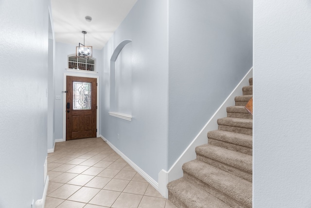 10305 Matador Dr, Mckinney, TX 75072 - foyer entrance with light tile patterned floors, stairs, and a chandelier