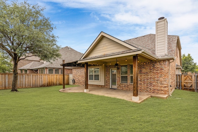 10305 Matador Dr, Mckinney, TX 75072 - back of property with a fenced backyard, a patio, a chimney, and brick siding