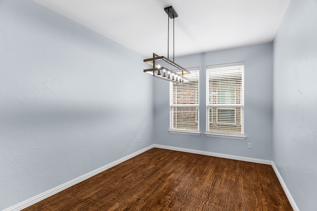 10305 Matador Dr, Mckinney, TX 75072 - unfurnished dining area with baseboards and dark wood-style floors
