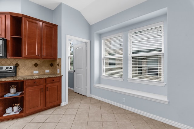 10305 Matador Dr, Mckinney, TX 75072 - kitchen with open shelves, lofted ceiling, light tile patterned floors, tasteful backsplash, and stainless steel microwave