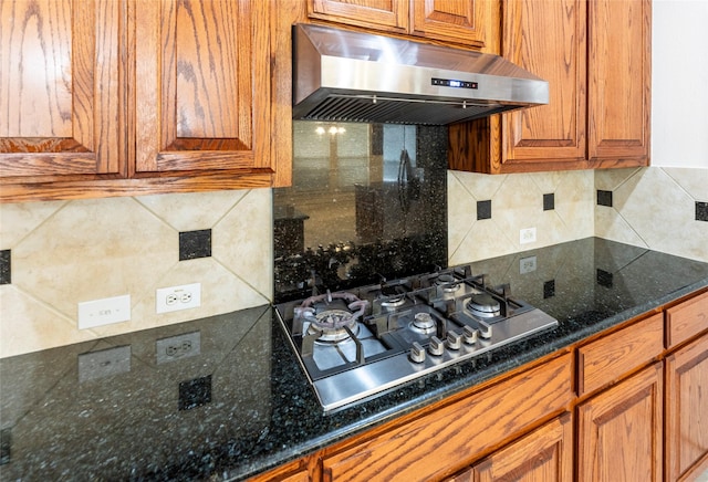 220 Justin Rd, Murphy, TX 75094 - kitchen featuring under cabinet range hood, stainless steel gas cooktop, brown cabinets, and decorative backsplash