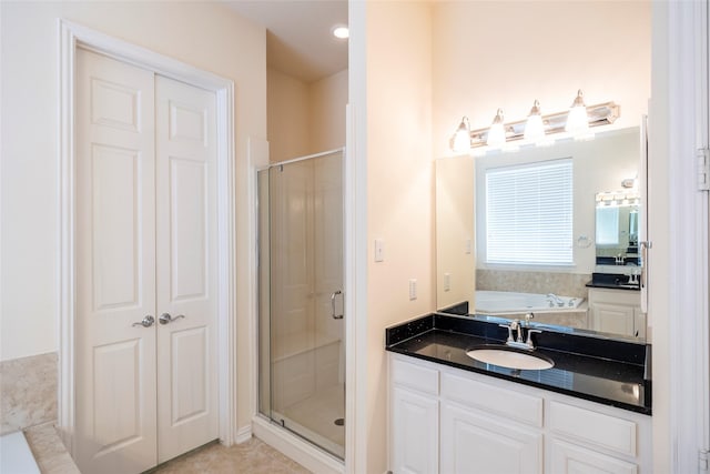 220 Justin Rd, Murphy, TX 75094 - bathroom with a shower stall, a garden tub, vanity, and tile patterned floors