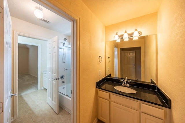 220 Justin Rd, Murphy, TX 75094 - bathroom featuring vanity, combined bath / shower with glass door, tile patterned flooring, and a textured wall