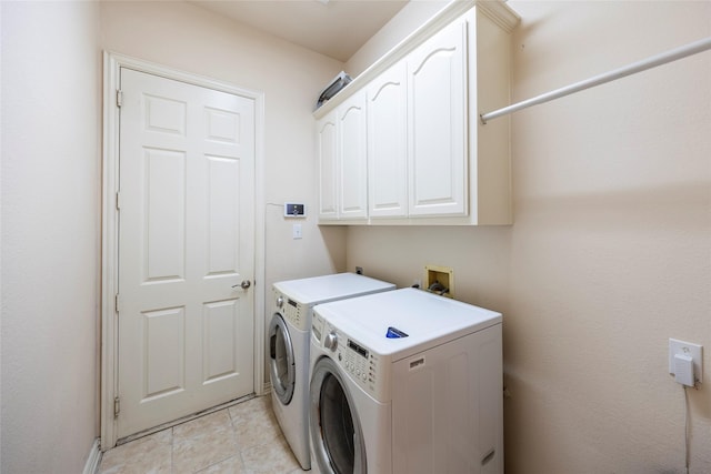 220 Justin Rd, Murphy, TX 75094 - washroom featuring washer and dryer, cabinet space, and light tile patterned flooring