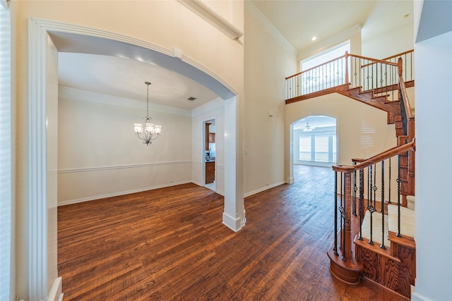 220 Justin Rd, Murphy, TX 75094 - entryway with arched walkways, crown molding, stairway, wood finished floors, and a chandelier