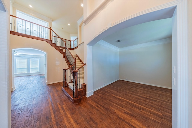 220 Justin Rd, Murphy, TX 75094 - stairway featuring arched walkways, healthy amount of natural light, wood finished floors, crown molding, and recessed lighting