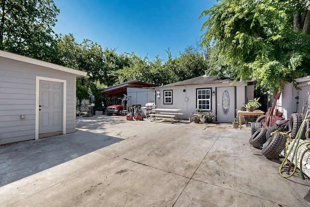 3832 Mount Ranier St, Dallas, TX 75211 - view of front of house featuring an outdoor structure and a patio area