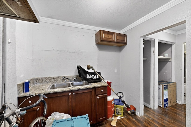 3832 Mount Ranier St, Dallas, TX 75211 - kitchen featuring dark wood-style flooring, ornamental molding, a textured ceiling, and light stone counters