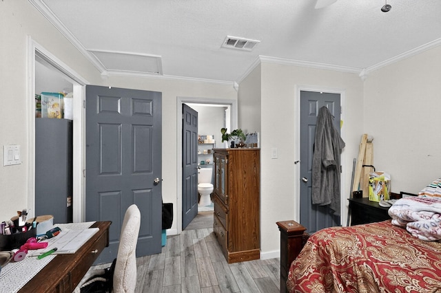 3832 Mount Ranier St, Dallas, TX 75211 - bedroom with light wood finished floors, ornamental molding, attic access, and ensuite bath