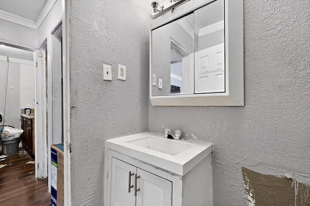 3832 Mount Ranier St, Dallas, TX 75211 - bathroom with a textured wall, vanity, ornamental molding, and wood finished floors