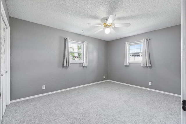 1610 Newsom Ct, Pantego, TX 76013 - empty room with plenty of natural light, carpet floors, a ceiling fan, and a textured ceiling
