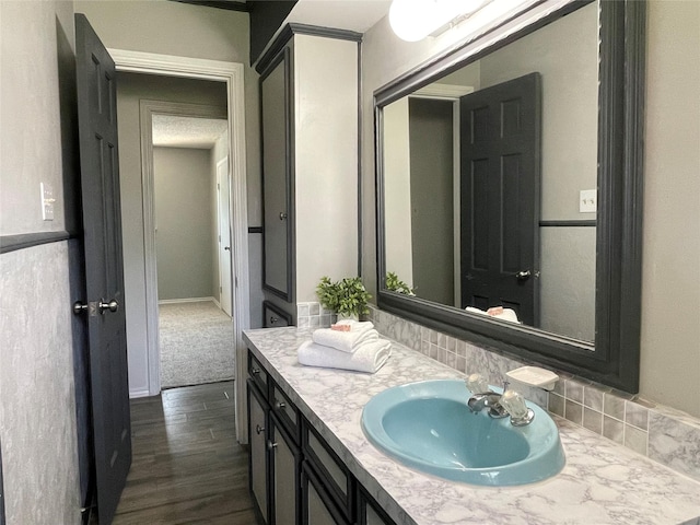 1610 Newsom Ct, Pantego, TX 76013 - bathroom featuring vanity, wood finished floors, and backsplash