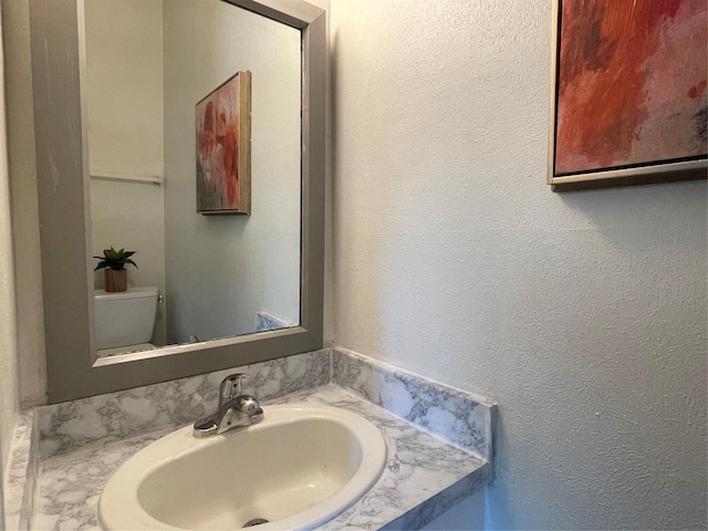 1610 Newsom Ct, Pantego, TX 76013 - bathroom with vanity and a textured wall
